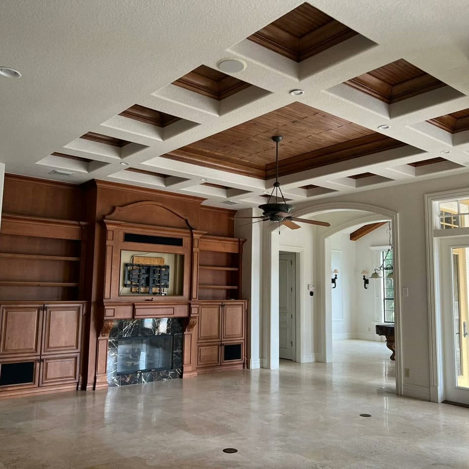 A finished double-height interior with arched windows, crown moulding
                    and freshly painted walls.